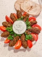 Kofta kebabs with yogurt dip and tomatoes
